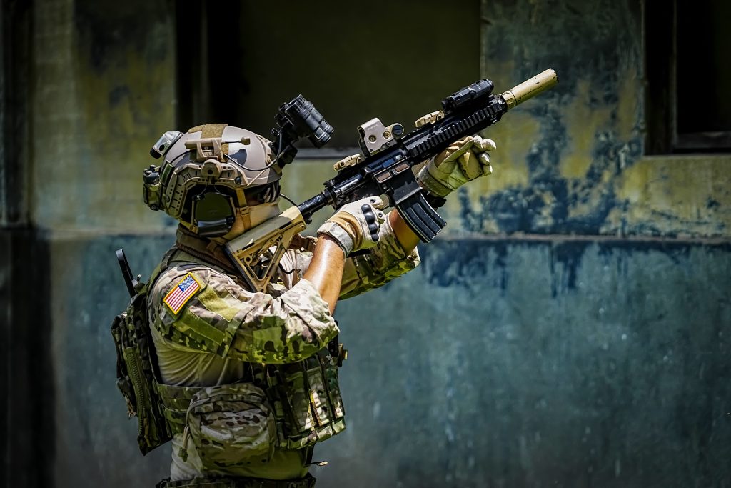 United States Army ranger during the military operation. Professional marine soldiers training with weapon on a military range.