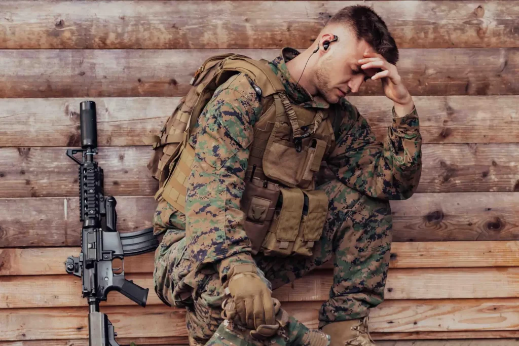 Marine struggling, sitting next to his rifle